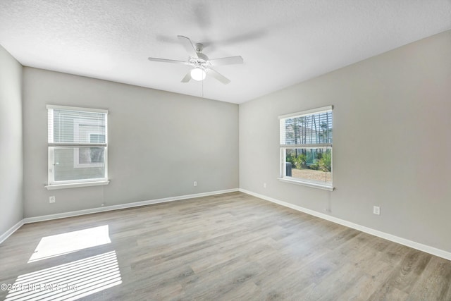 unfurnished room featuring ceiling fan, a textured ceiling, and light hardwood / wood-style floors