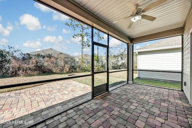 unfurnished sunroom with ceiling fan and plenty of natural light