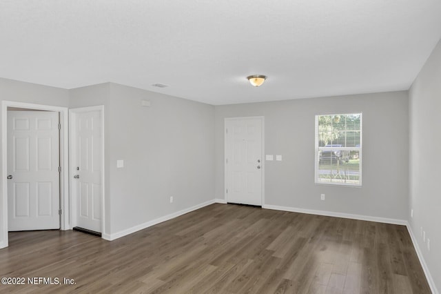 spare room with dark hardwood / wood-style floors