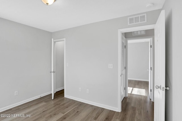 spare room with hardwood / wood-style floors