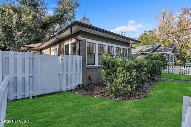 view of home's exterior featuring a lawn