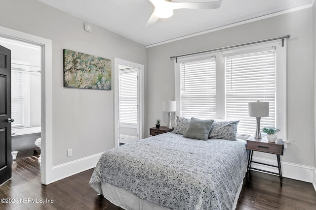 bedroom with ceiling fan, ensuite bathroom, dark wood-type flooring, and crown molding