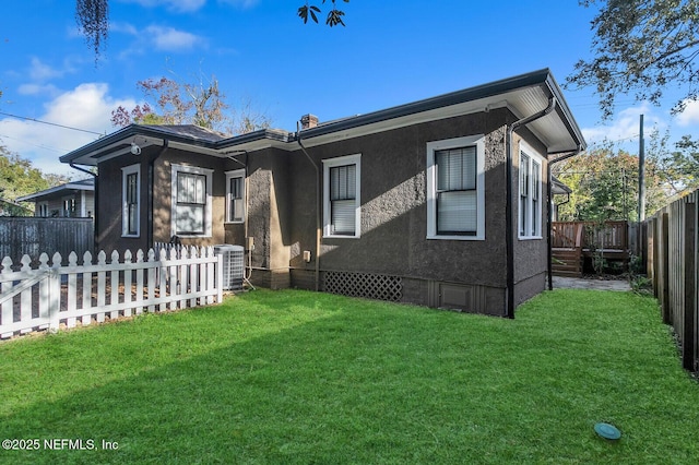 view of front of house with a front lawn and cooling unit