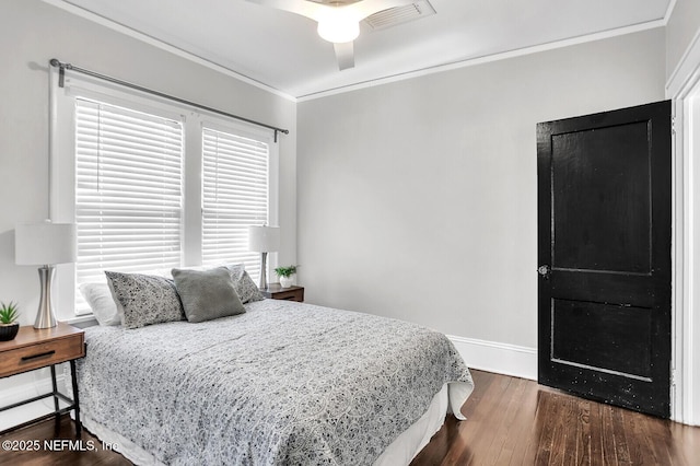 bedroom featuring ceiling fan, dark hardwood / wood-style flooring, and ornamental molding