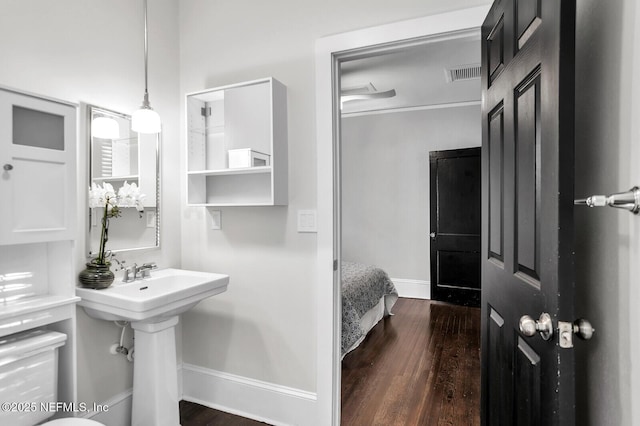 bathroom with hardwood / wood-style flooring