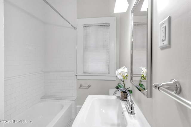 bathroom featuring shower / bath combination and sink