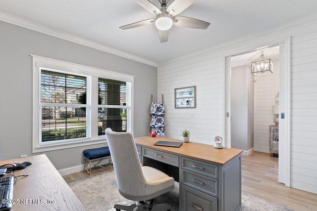 home office with ceiling fan with notable chandelier, light wood-type flooring, and crown molding