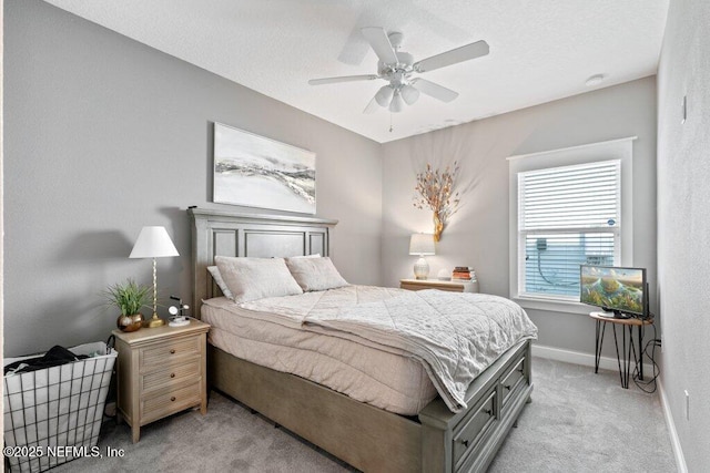 bedroom featuring ceiling fan and light colored carpet