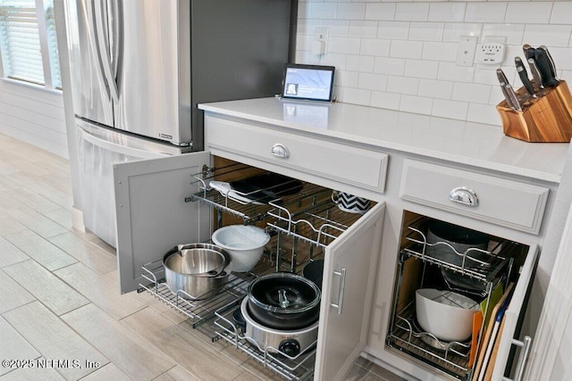 details with stainless steel fridge and tasteful backsplash