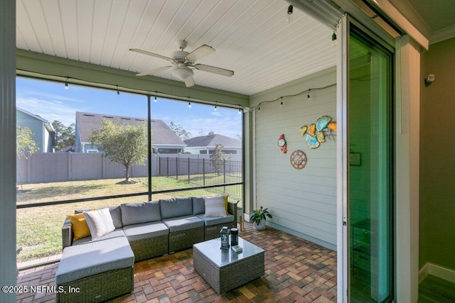 sunroom / solarium with ceiling fan