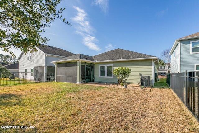 back of house with a lawn, a sunroom, and central AC unit