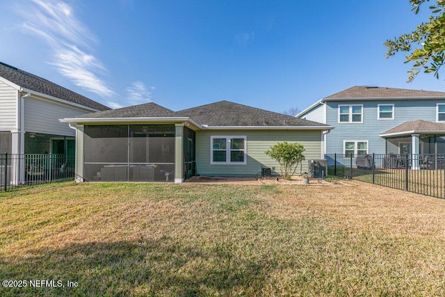 back of property with a sunroom, cooling unit, and a yard