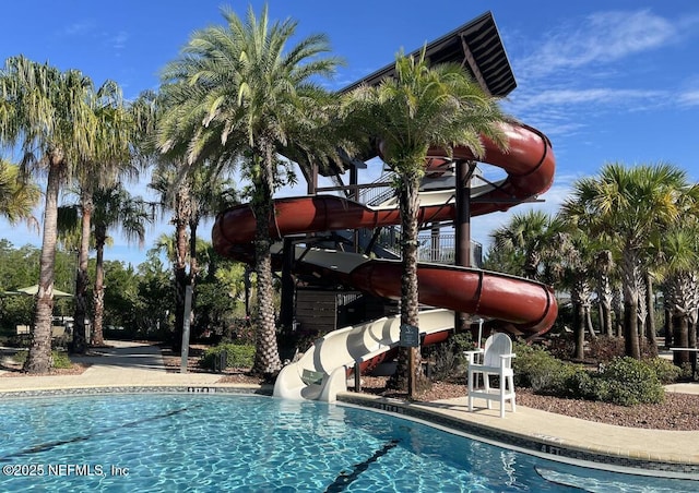 view of swimming pool with a water slide