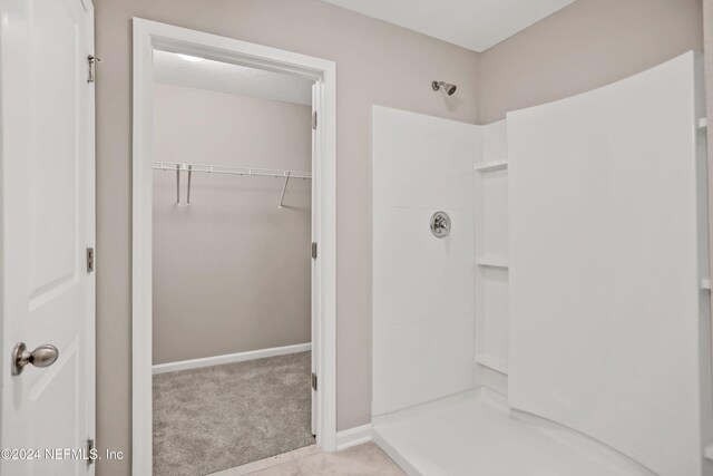 bathroom featuring tile patterned flooring and walk in shower