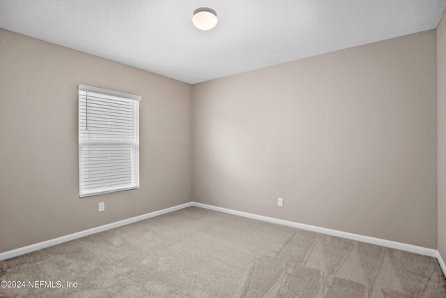 unfurnished room featuring carpet