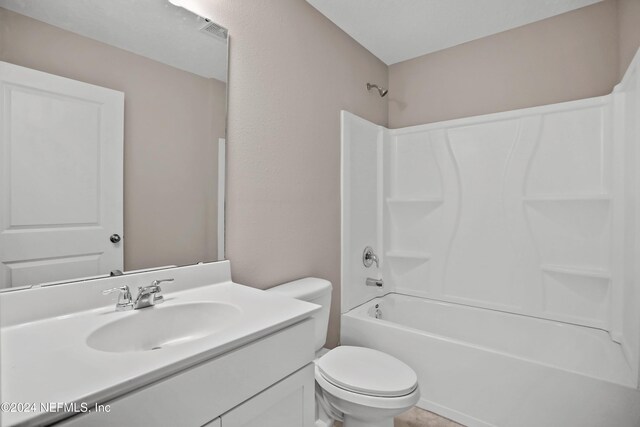 full bathroom with vanity, toilet, and shower / washtub combination