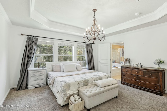 carpeted bedroom with ornamental molding, a raised ceiling, ensuite bath, and an inviting chandelier