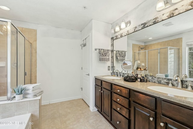 bathroom featuring a shower with shower door, vanity, and tile patterned floors