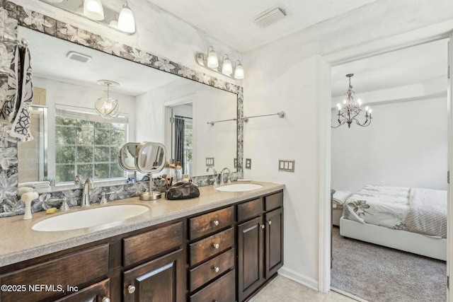 bathroom with vanity and a chandelier