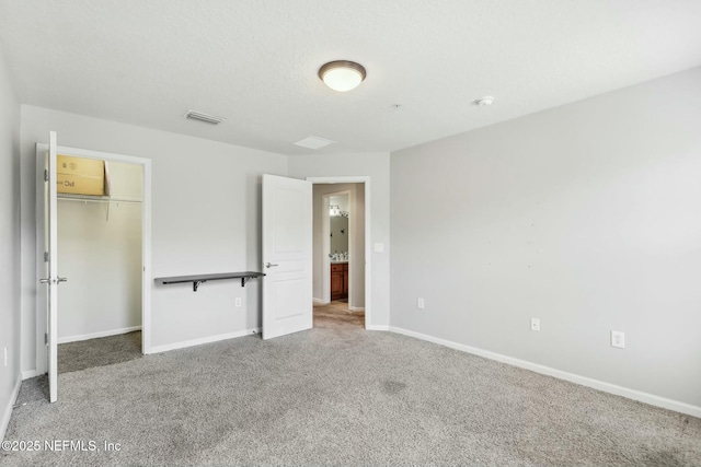 unfurnished bedroom with carpet floors, a closet, and a textured ceiling