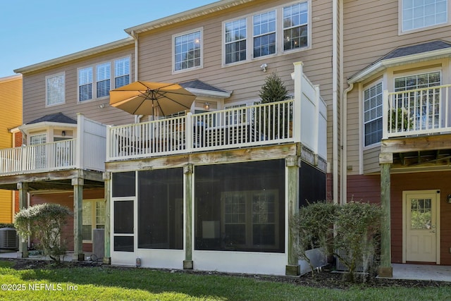 back of house featuring a sunroom