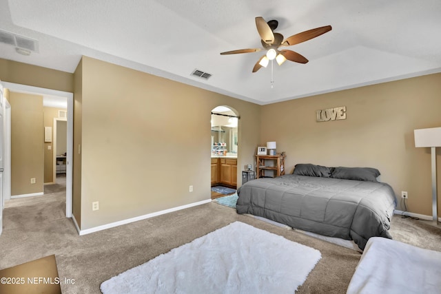 carpeted bedroom featuring ceiling fan and ensuite bathroom