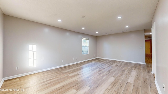 unfurnished room featuring light hardwood / wood-style floors