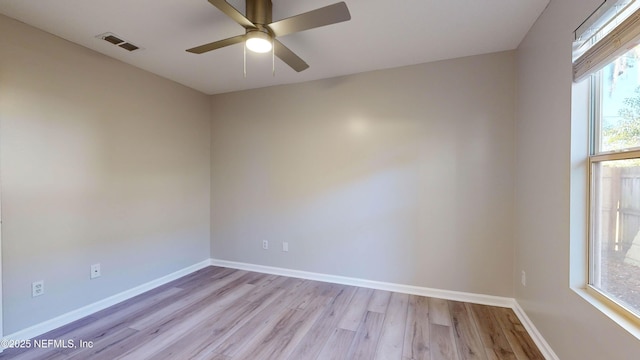 spare room with light wood-type flooring and ceiling fan