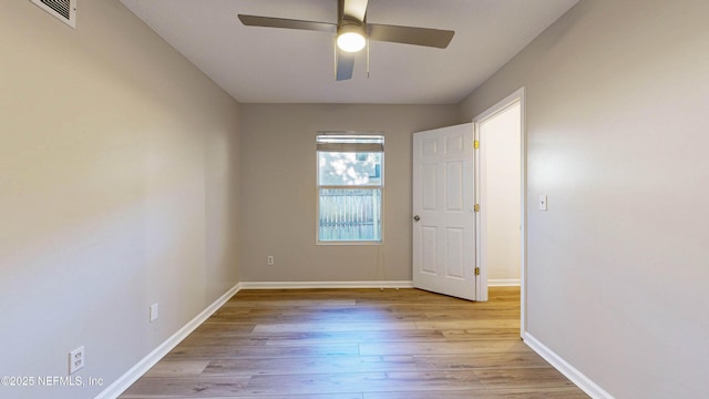 spare room with light wood-type flooring and ceiling fan