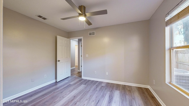 unfurnished room featuring ceiling fan and light wood-type flooring