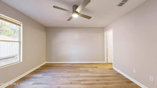 empty room with ceiling fan, light hardwood / wood-style flooring, and a wealth of natural light