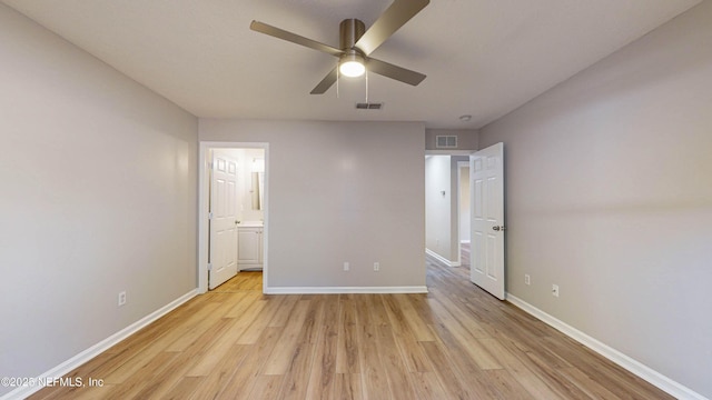 unfurnished bedroom with connected bathroom, ceiling fan, and light wood-type flooring