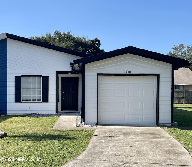 ranch-style home with a garage and a front lawn