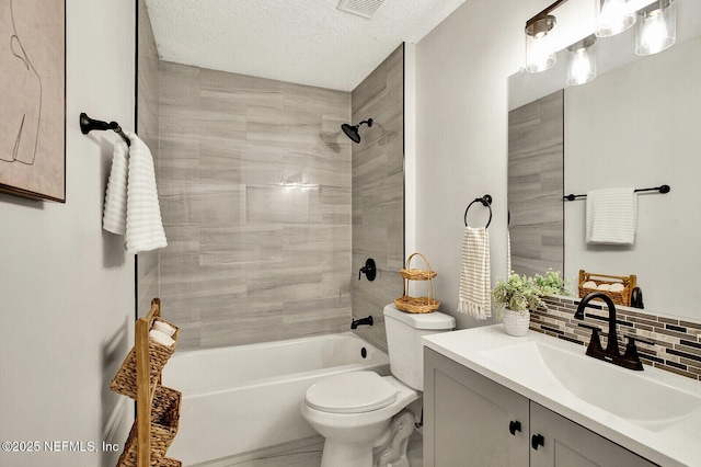 full bathroom with a textured ceiling, toilet, decorative backsplash, vanity, and tiled shower / bath