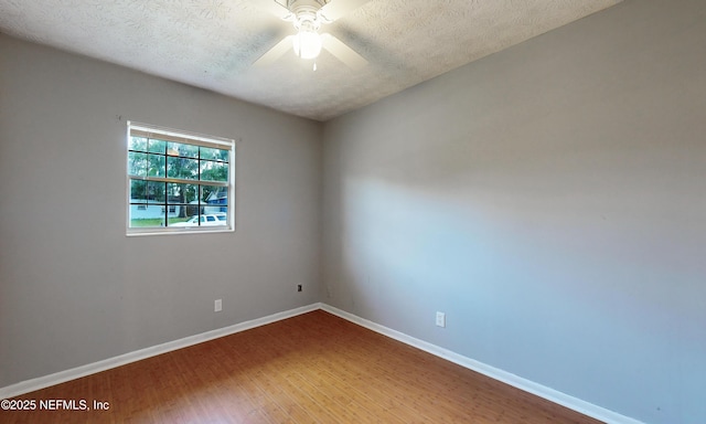 unfurnished room with hardwood / wood-style flooring, ceiling fan, and a textured ceiling