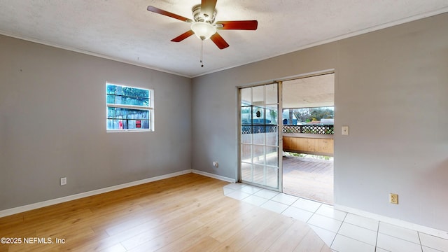 spare room featuring a textured ceiling, ceiling fan, light wood-type flooring, and crown molding