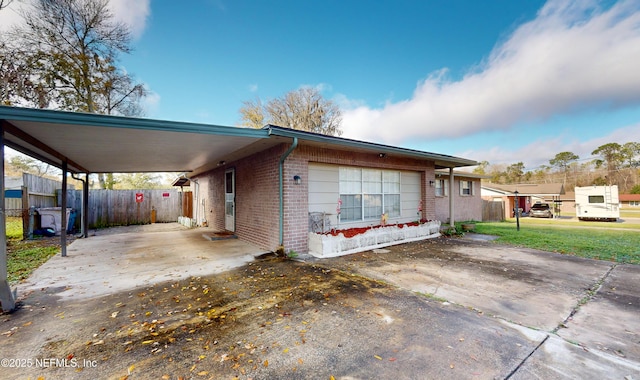 view of front of property with a front lawn and a carport