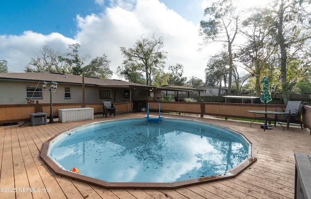 view of pool with a wooden deck