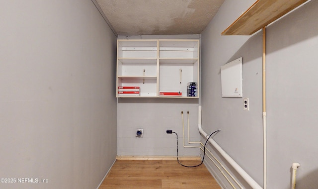 laundry room with light hardwood / wood-style flooring