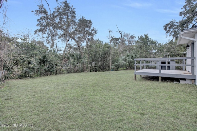 view of yard with a wooden deck