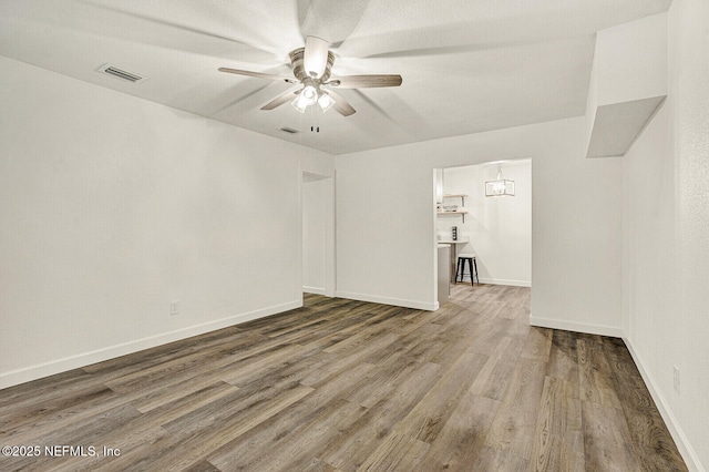 spare room featuring hardwood / wood-style flooring and ceiling fan