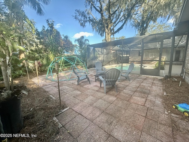 view of patio with glass enclosure