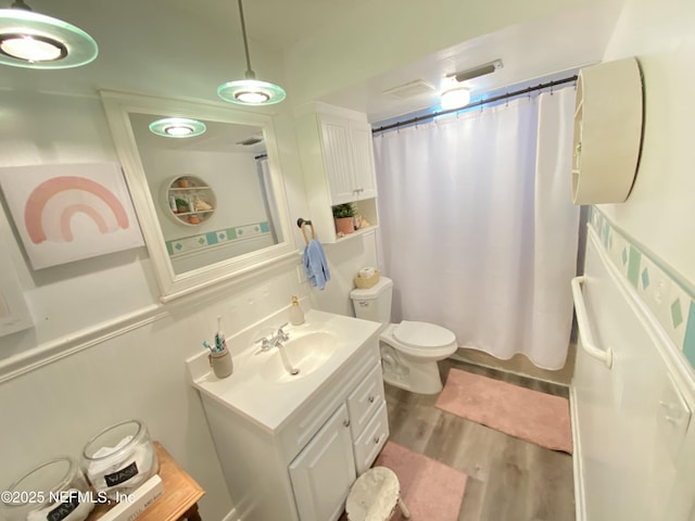 bathroom featuring toilet, hardwood / wood-style floors, vanity, and a shower with shower curtain