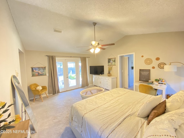 carpeted bedroom featuring access to outside, french doors, vaulted ceiling, ceiling fan, and a textured ceiling