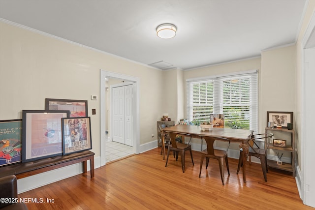 dining room featuring light wood-type flooring and ornamental molding