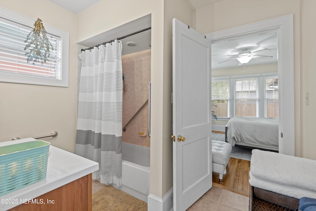 bathroom with tile patterned flooring, ceiling fan, and shower / bath combo with shower curtain