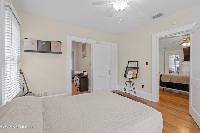 bedroom featuring light hardwood / wood-style floors and ceiling fan