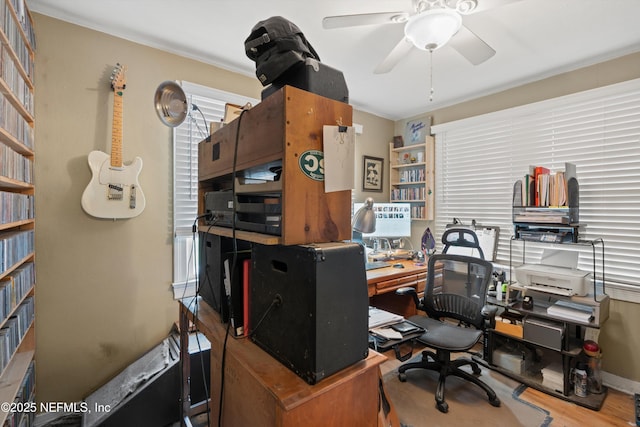 office with ceiling fan and crown molding