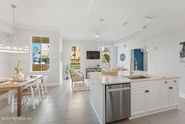 kitchen featuring ceiling fan, sink, dishwasher, white cabinets, and an island with sink