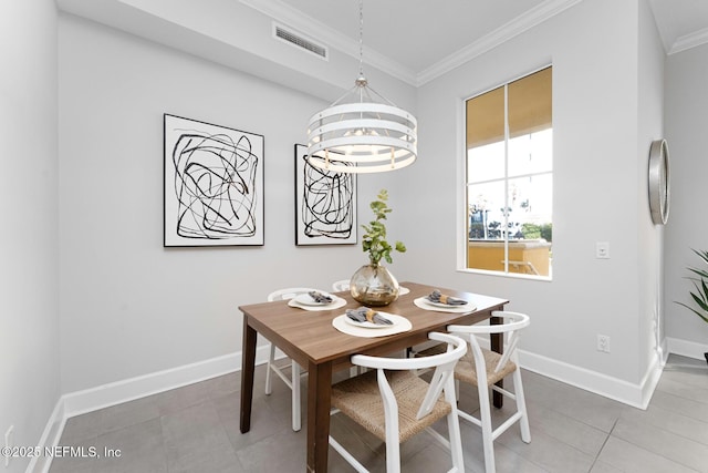 tiled dining space featuring an inviting chandelier and crown molding